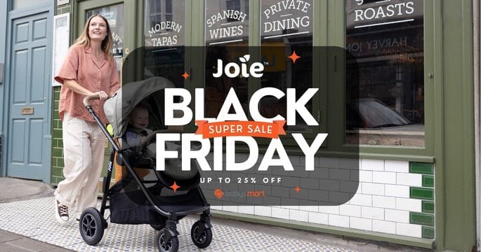 Woman with a stroller in front of a store window with 'Joie Black Friday' sale text.